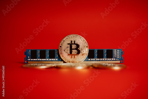 gold coins bitcoin and RAM on a red background