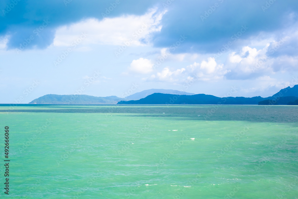 Seascape. Azure sea, mountains and sky with clouds. Travel and tourism