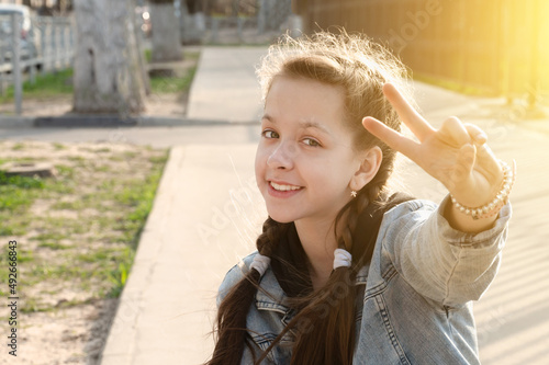 pretty attractive young girl shows victory sign 