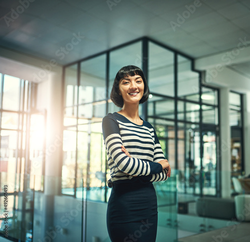 Free Download Young and ambitious. Portrait of a confident young businesswoman standing in an office. - GFXLoad