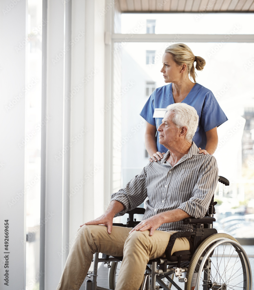 Making sure hes not cooped up in his recovery room. Cropped shot of a mature female nurse and her senior male wheelchair-bound patient in the hospital. Making sure hes not cooped up in his recovery room. Cropped shot of a mature female nurse and her senior male wheelchair-bound patient in the hospital.