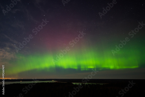 Aurora borealis, The Northern lights at the lake Usma and forest, Latvia. Aerial view. © Bargais