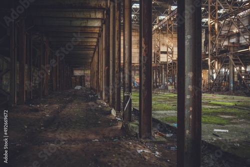 The sun s rays break through the roof of an abandoned warehouse 