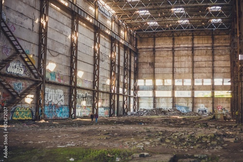 The sun's rays break through the roof of an abandoned warehouse 