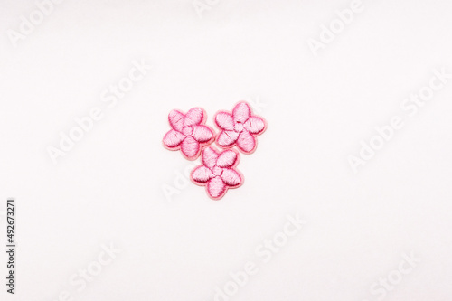 Pink floral textile patches for clothes customization, isolated on white.