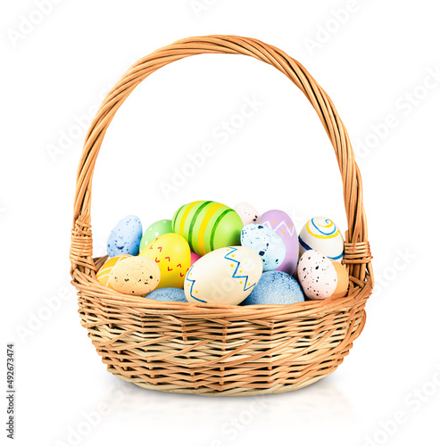 wicker basket with easter eggs on a white isolated background