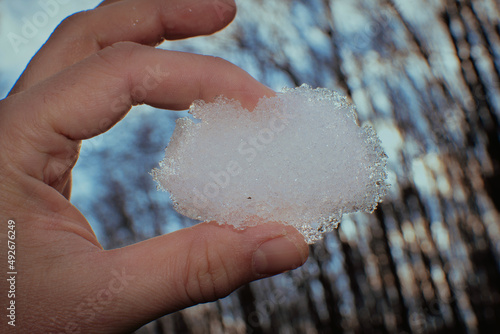 Closeup snow heart in male hands outdoors