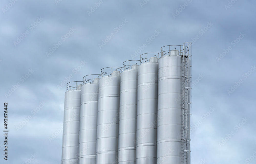 Industrial stainless steel tanks at a modern factory.