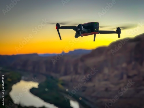 Drone flying over cliffs during sunset 