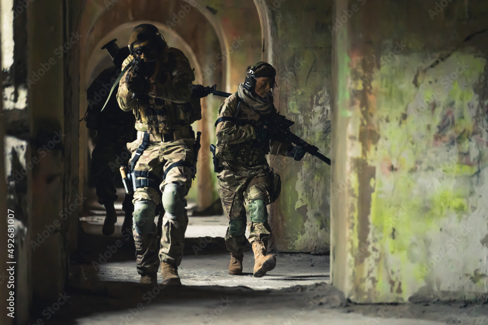 Fototapeta premium Sly squad troops sneaking into domicile building. High quality photo