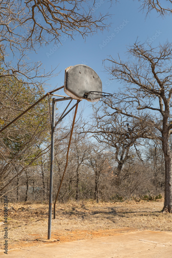 Rusty old double basketball hoop in the park, outdoor recreation area. Rusty old double basketball hoop in the park, outdoor recreation area.
