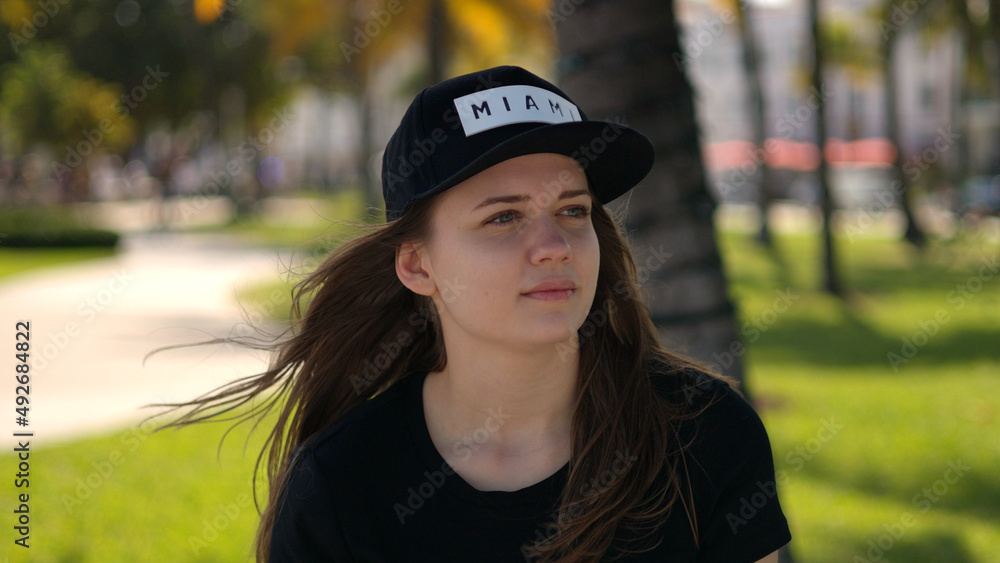 Close up shot of a pretty girl under palm trees at the beach Close up shot of a pretty girl under palm trees at the beach