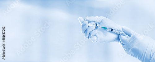 Hand holding viol with vaccine against corona virus. photo