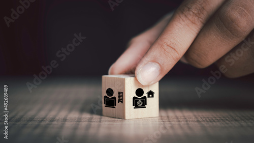 Hybrid workplace schedule, Gig economy, Freelance, Online business network communication, teamwork, home office concept. Hand hold wooden cube  icon of gig economy, copy space for background or text. photo