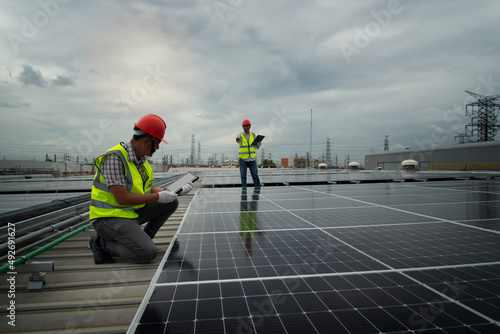 workers at work. Solar cells have been maintained and maintenance by a team of engineers. two engineers checking solar cells. Solar cells have been maintained and maintenance by a team of engineers. 