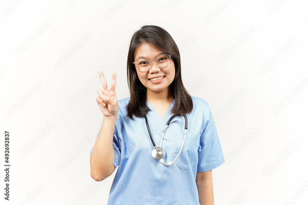 Showing Peace Sign Of Asian Young Doctor Isolated On White Background Showing Peace Sign Of Asian Young Doctor Isolated On White Background