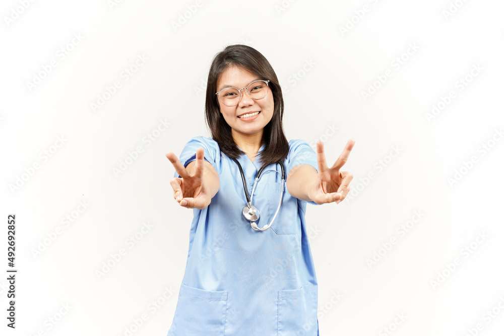 Showing Peace Sign Of Asian Young Doctor Isolated On White Background Showing Peace Sign Of Asian Young Doctor Isolated On White Background