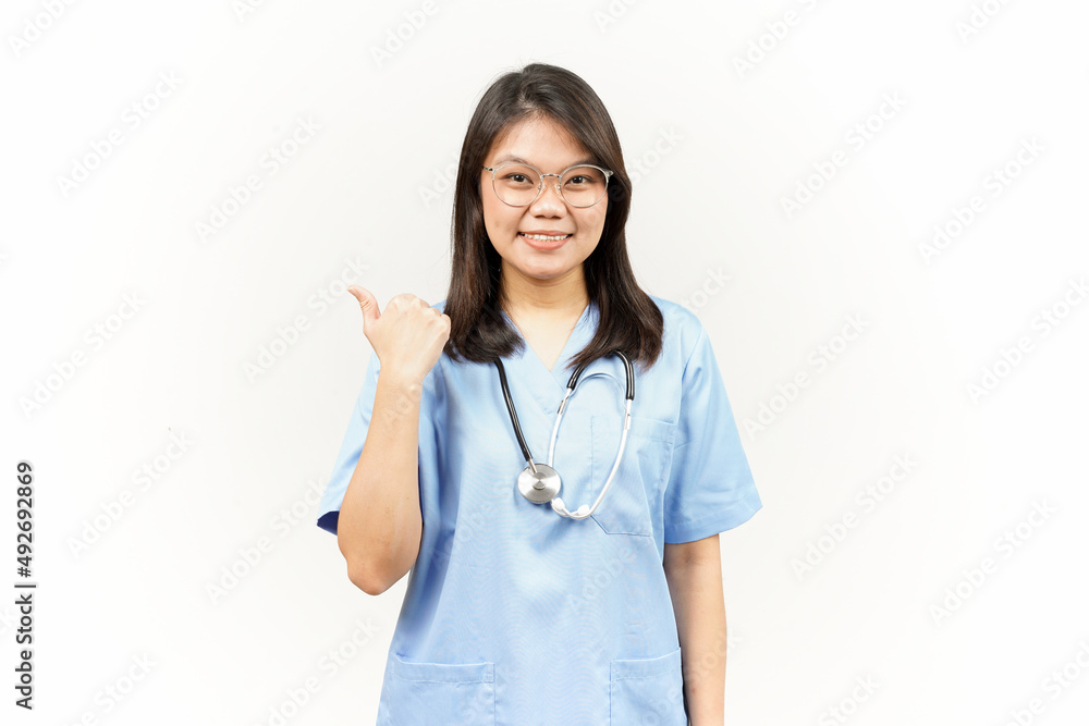 Showing and Pointing Product With Thumb Of Asian Young Doctor Isolated On White Background Showing and Pointing Product With Thumb Of Asian Young Doctor Isolated On White Background