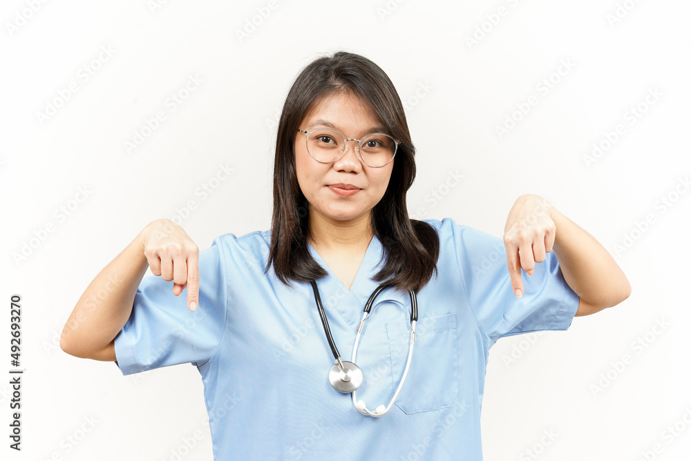 Showing Product and Pointing Down Of Asian Young Doctor Isolated On White Background Showing Product and Pointing Down Of Asian Young Doctor Isolated On White Background