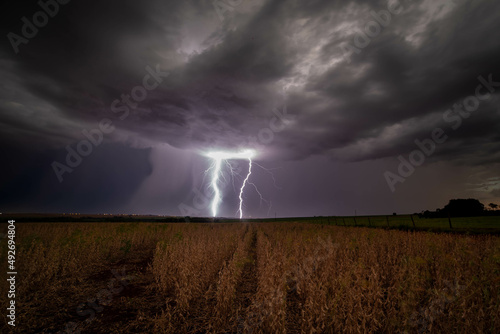 Twins lightning over a farm.