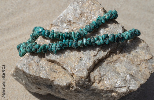 necklace of polished natural turquoise stones strung together and displayed on a chunk of rough quartzite © Diane N. Ennis