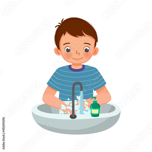 Little boy washing hands with antibacterial soap and running water under faucet at the sink 