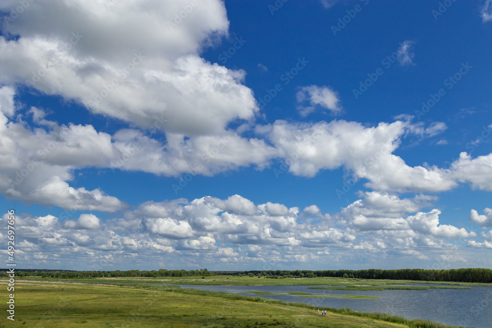 Nature summer landscape with tributary of Irtysh river and bright blue sky with clouds. Natural background and beautiful place