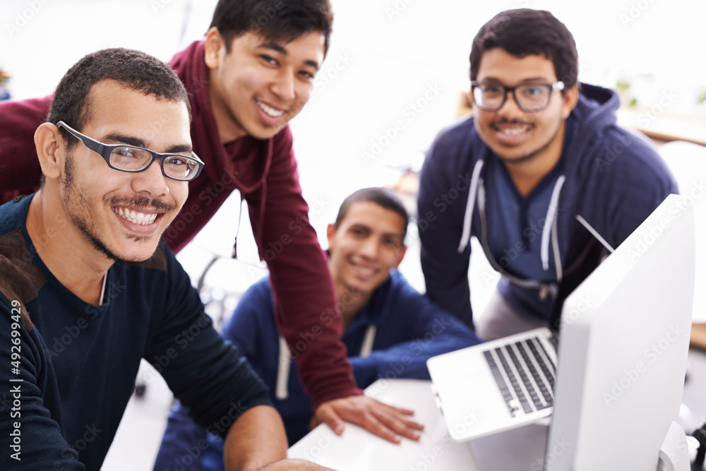 Workshopping an idea. Cropped shot of young students gathered around a computer. Workshopping an idea. Cropped shot of young students gathered around a computer.