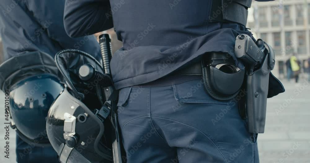 Police cops in riot gear protest helmet baton stick guns in close up Police cops in riot gear protest helmet baton stick guns in close up