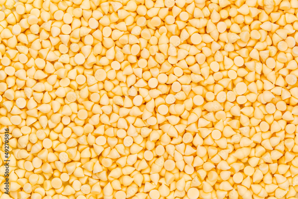 Top view pile of milk white chocolate chips use as the background. Top view pile of milk white chocolate chips use as the background.
