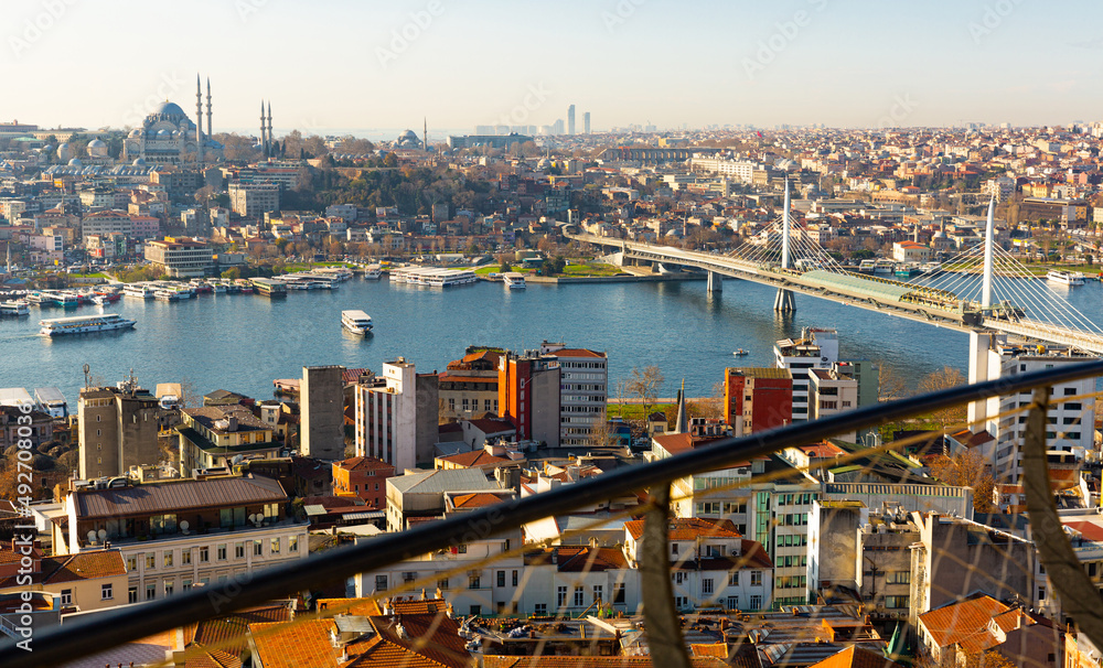 View from Galata Tower of Golden Horn bay with cable-stayed metro bridge connecting Beyoglu and Fatih districts, Suleymaniye Mosque in background, Istanbul, Turkey..