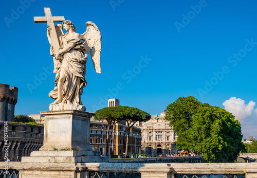 Angel with the Cross statue by Ercole Ferrata on Ponte Sant'Angelo Saint Angel Bridge over Tiber river in historic city center of Rome in Italy photo