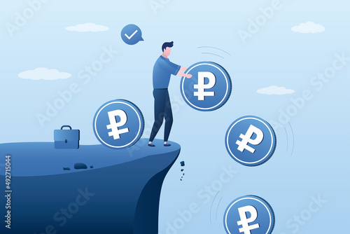 Male investor or trader standing on cliff and drops ruble coins. Frustrated investor gets rid of russian currency. Financial losses from investments in russian economic.
