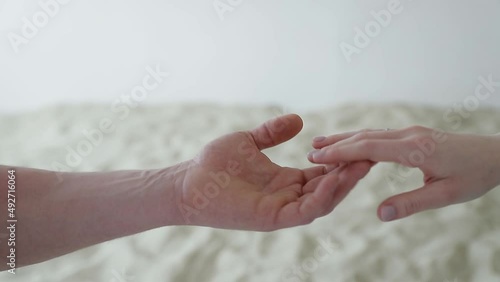 male and female hands touch and separate