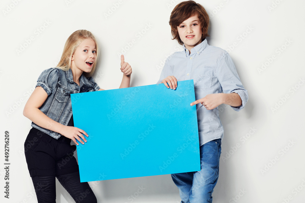 Heres the perfect answer. Shot of two young kids holding copy.space.