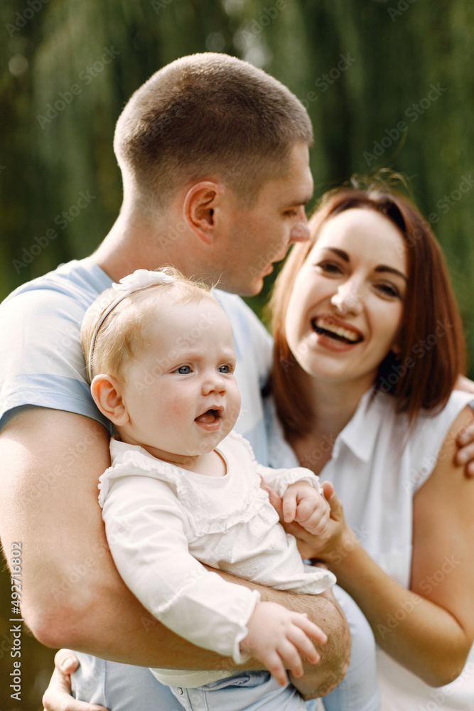 Happy family resting in park near the lake Happy family resting in park near the lake