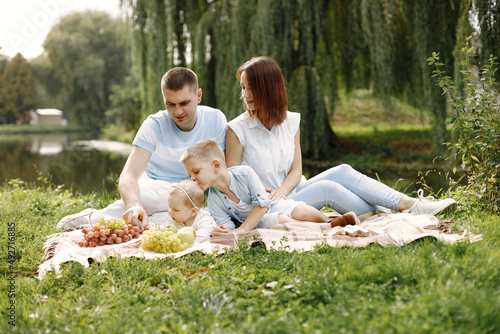 Happy family resting in park near the lake © hetmanstock2
