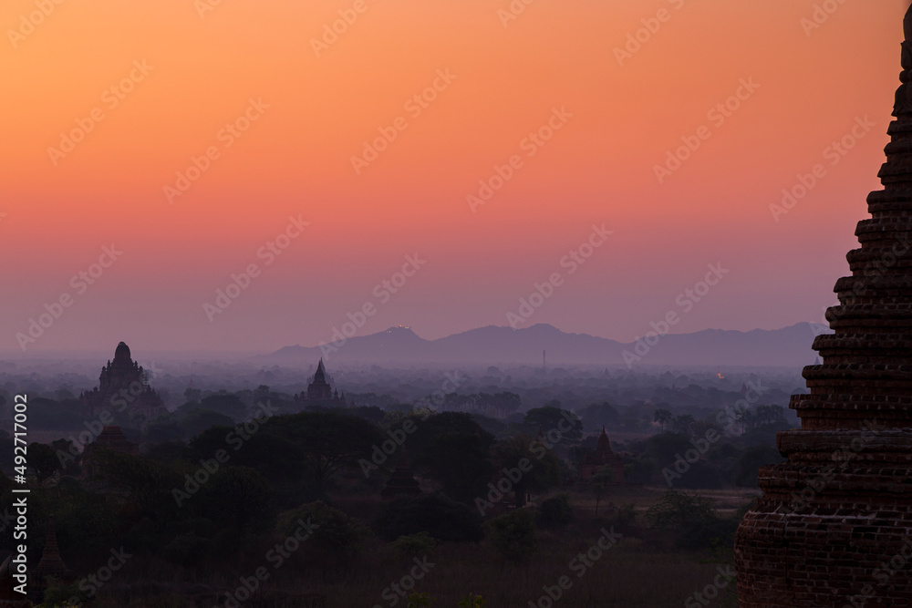 Silhouette of pagodas and temples at misty plain in Bagan, Myanmar (Burma), at dawn, viewed slightly from above. Silhouette of pagodas and temples at misty plain in Bagan, Myanmar (Burma), at dawn, viewed slightly from above.