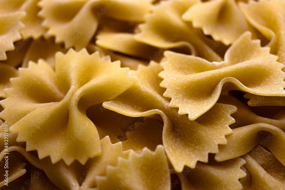 Pasta bows from durum wheat. Food background close up. Uncooked Italian pasta. Pasta bows from durum wheat. Food background close up. Uncooked Italian pasta.
