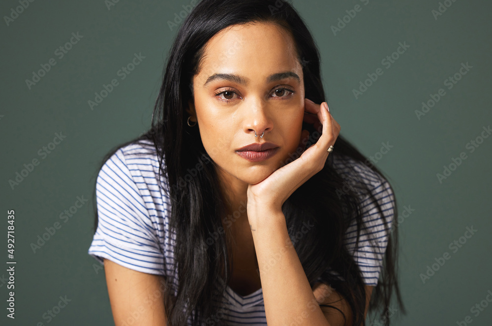 Sometimes the struggle is too much. Cropped portrait of an attractive young woman looking depressed against a green background in studio. Sometimes the struggle is too much. Cropped portrait of an attractive young woman looking depressed against a green background in studio.