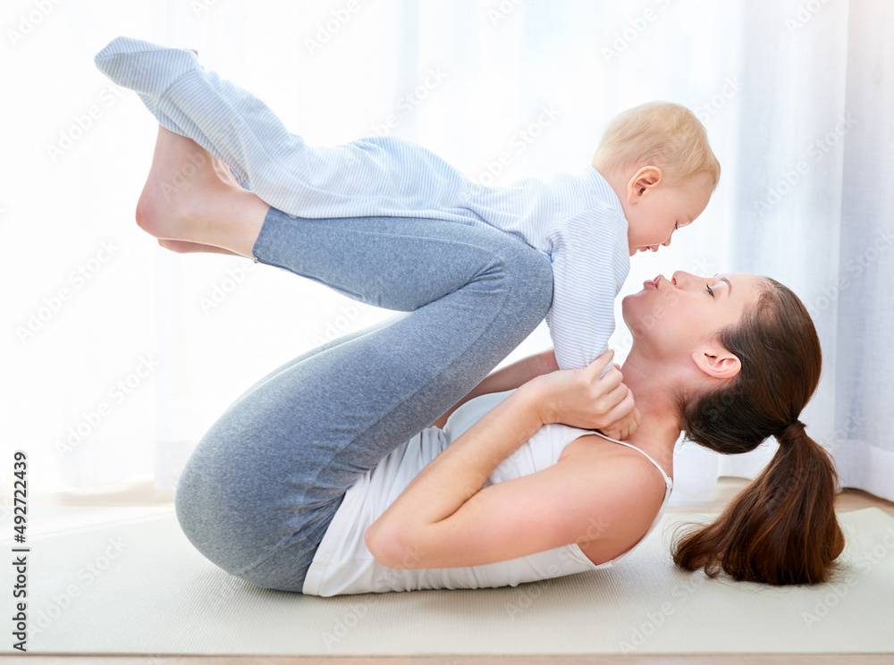 Youre gonna have to work harder for that kiss mom. Shot of a young woman working out while spending time with her baby boy. Youre gonna have to work harder for that kiss mom. Shot of a young woman working out while spending time with her baby boy.