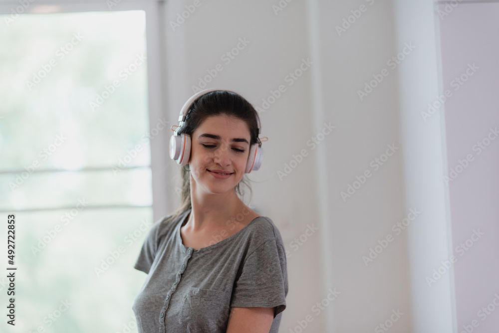 young woman person wearing earphone or headphone to relaxing with song on the bed in bedroom at home, concept of happy sound listen lifestyle in cozy audio feeling young woman person wearing earphone or headphone to relaxing with song on the bed in bedroom at home, concept of happy sound listen lifestyle in cozy audio feeling