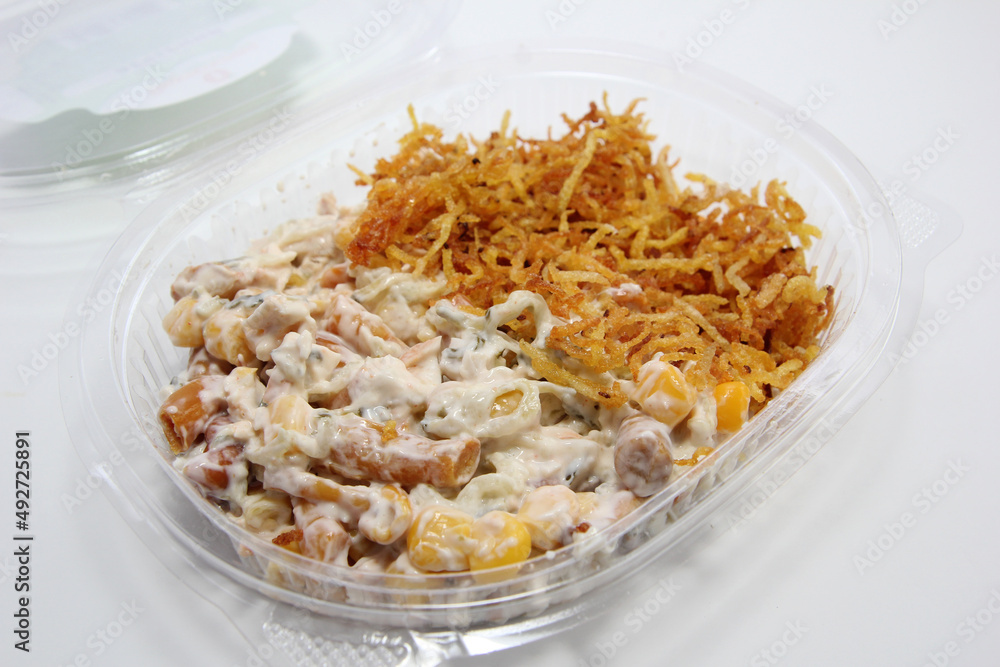 Evening salad with corn, mushrooms, french fries. Salad in a plastic disposable package. Evening salad with corn, mushrooms, french fries. Salad in a plastic disposable package.