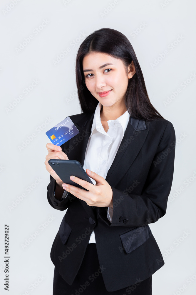 asian business woman wearing office clothing hands show credit card and use smart phone mobile, credits card and payment concept. asian business woman wearing office clothing hands show credit card and use smart phone mobile, credits card and payment concept.