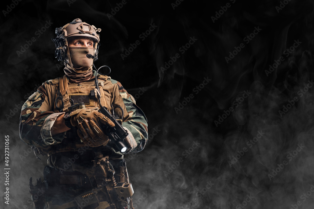 Military soldier dressed in camouflage uniform with helmet Military soldier dressed in camouflage uniform with helmet