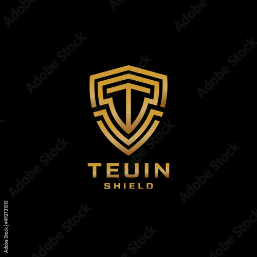 Letter T Logo With Shield Shape In Gold Color