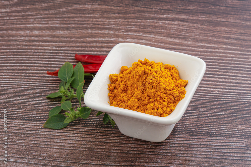 Yellow vibrant curcuma powder in the bowl Yellow vibrant curcuma powder in the bowl