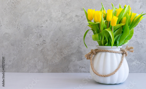 Fototapeta Naklejka Na Ścianę i Meble -  Bouquet of yellow tulips in a white vase