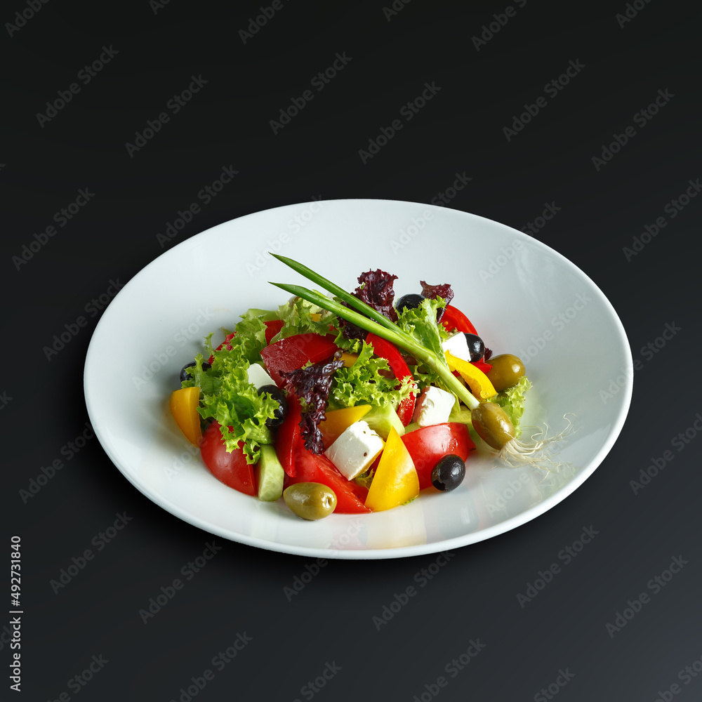 traditional dishes of European cuisine, delicacy, banquet snack. culinary dishes on a white plate on a black background. restaurant service