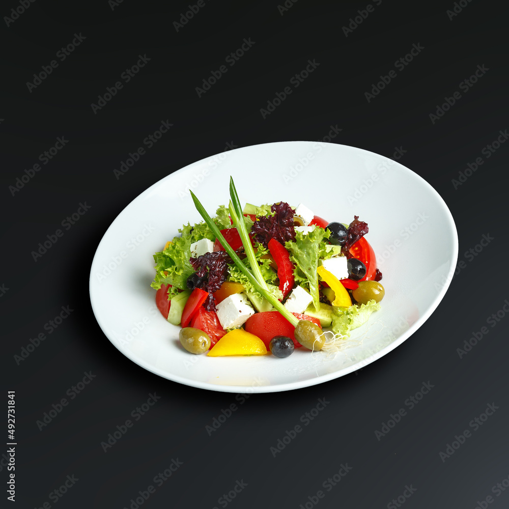 traditional dishes of European cuisine, delicacy, banquet snack. culinary dishes on a white plate on a black background. restaurant service